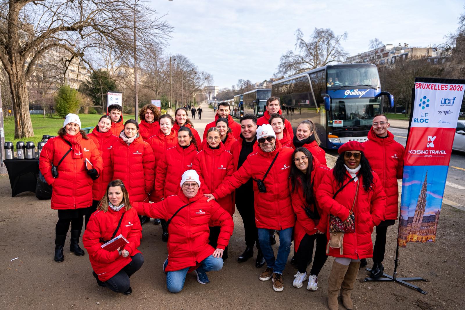 The Kosmo Travel Groups team in red jackets, coaches and the Bruxelles 2026 banner at Porte Dauphine